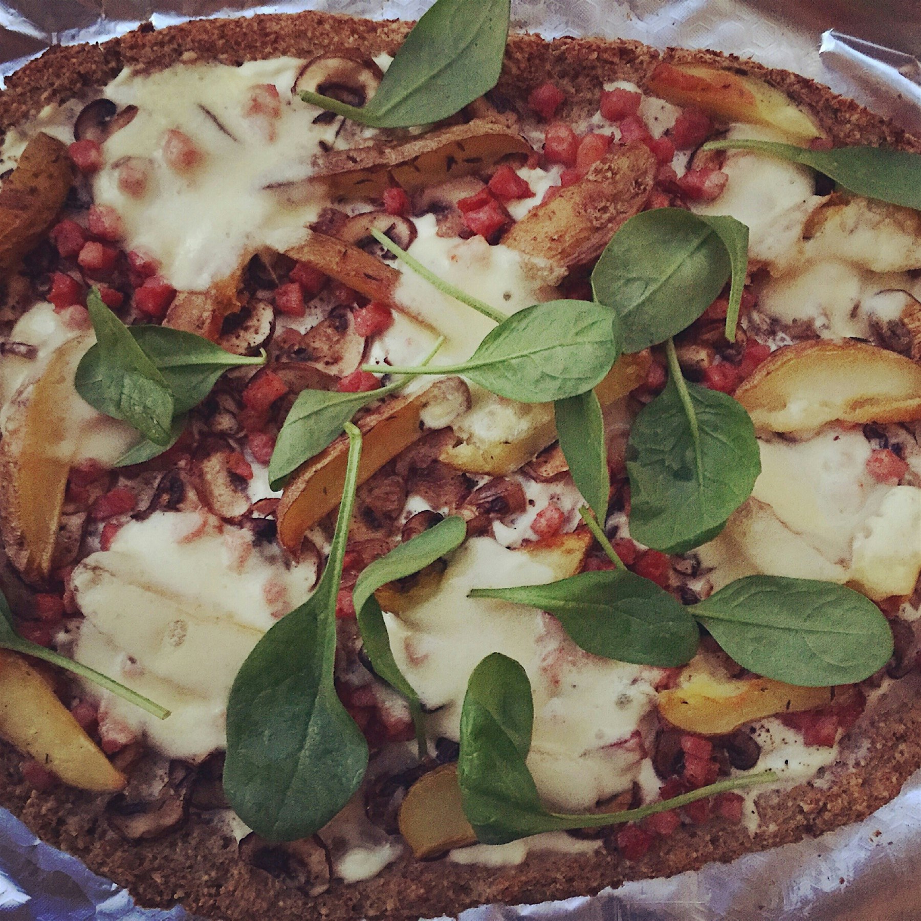 Cauliflower 'pizza' topped with creme fraiche, shallots, mushrooms, potato, speck, mozzarella and...