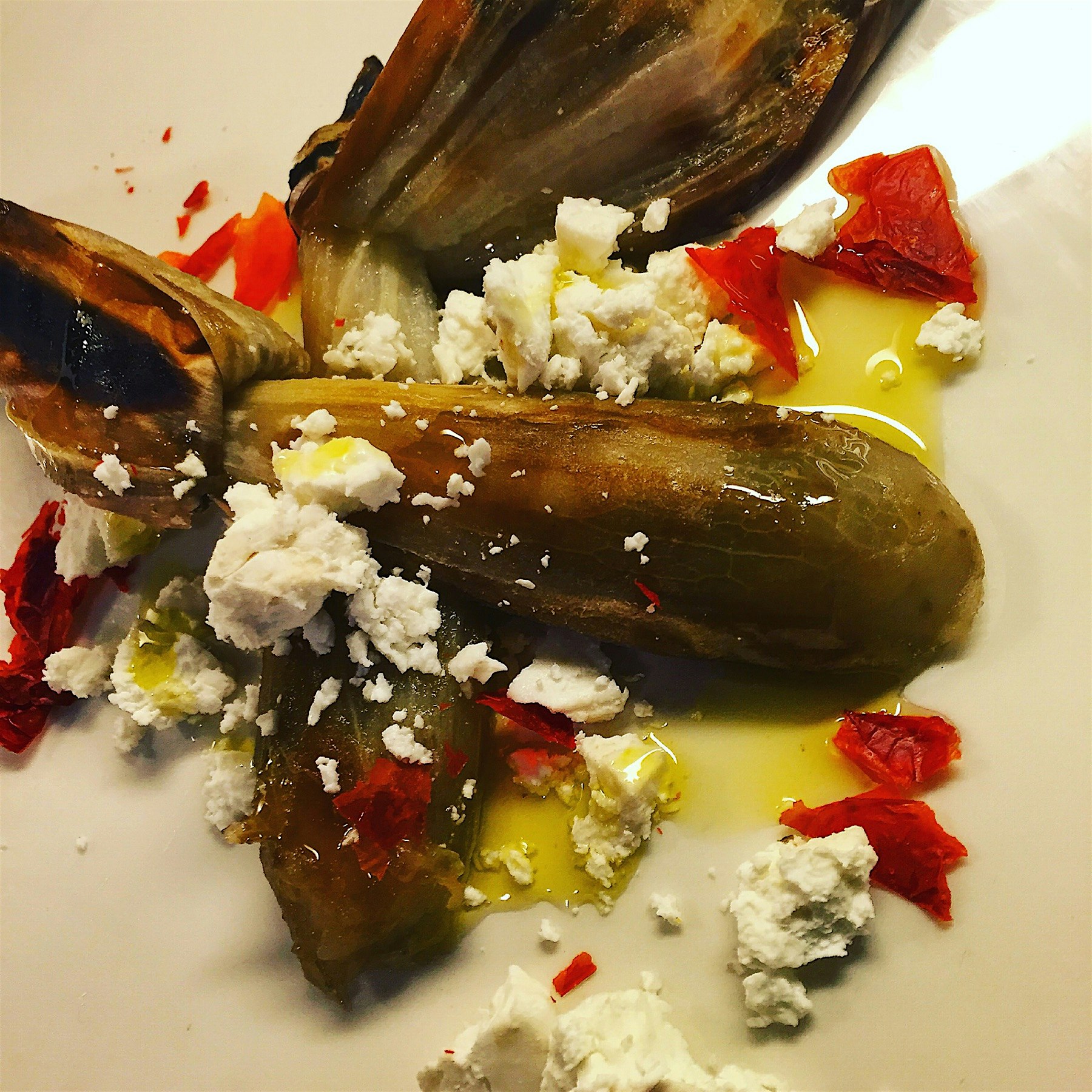 Charred eggplant, goats milk feta, dried tomato skins. 