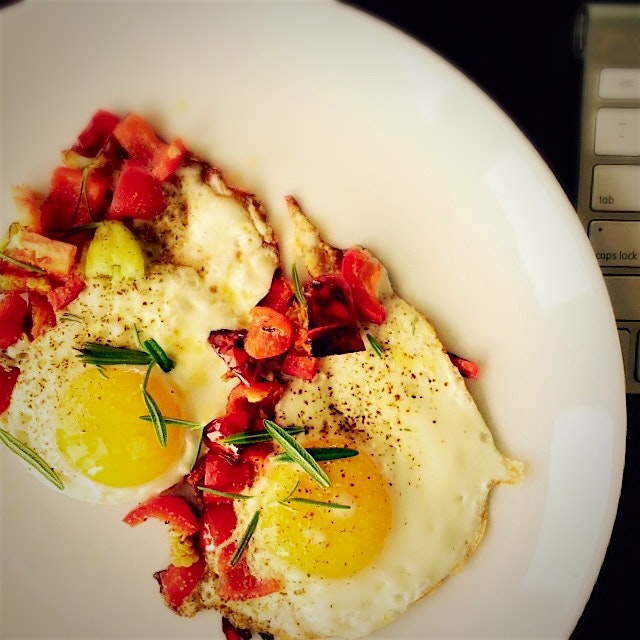 The upside of working from home today: sunnyside up eggs with sweet peppers and fresh rosemary fr...