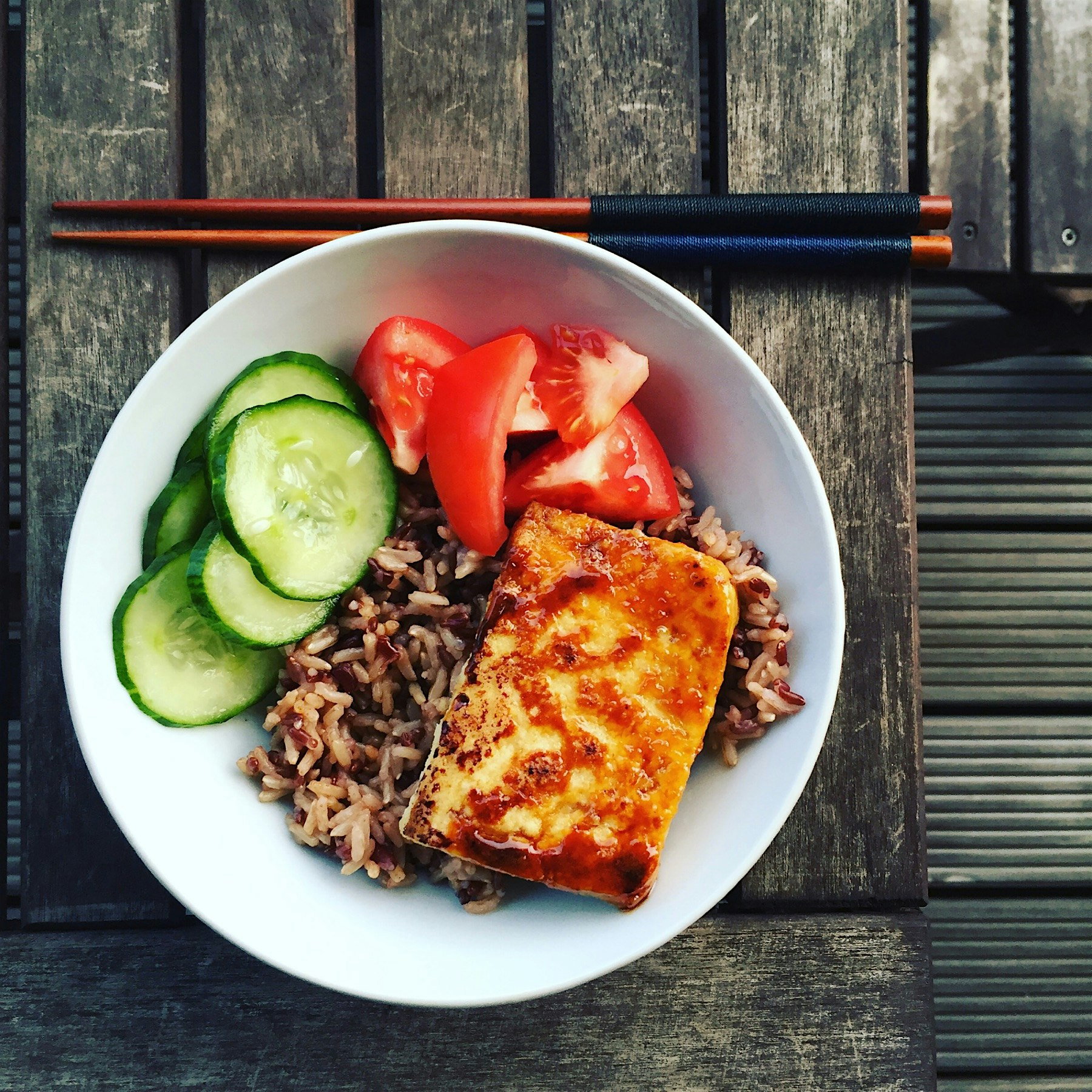 Simple dinner of Tamari tofu steak served with brown/red rice and pickled cucumber 