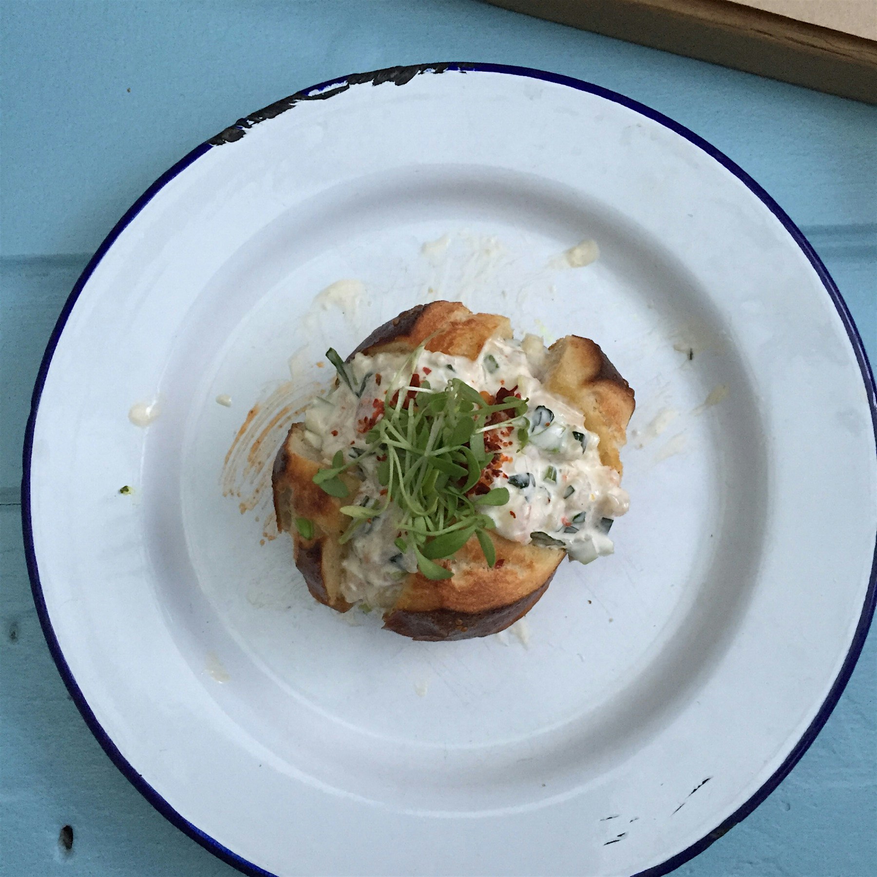 Pardon the dirty plate! Prawn salad in a pretzel bun is the new prawn cocktail. 