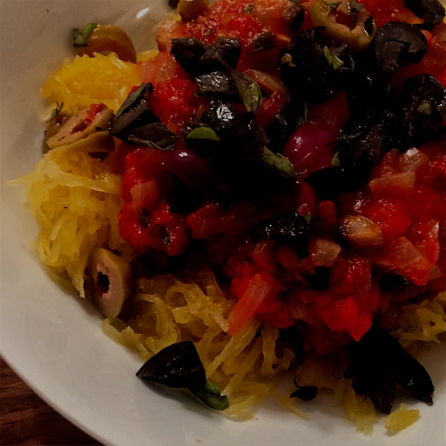 Spaghetti squash with homemade tomato sauce topped with olives and thyme 