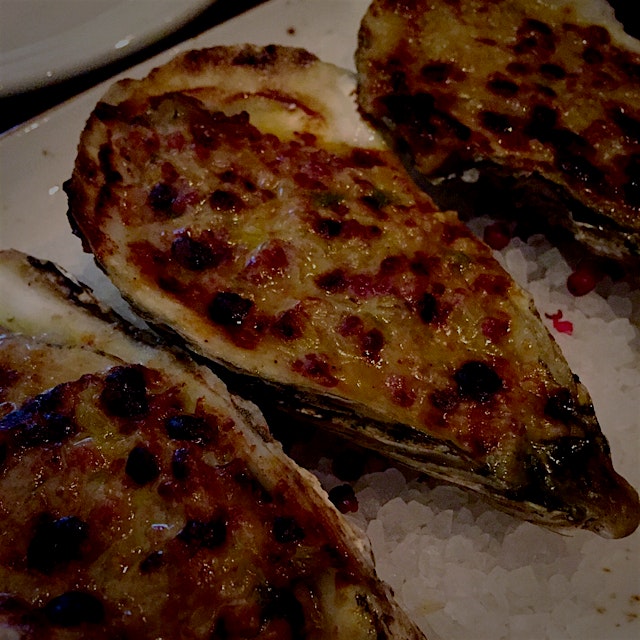 Baked oysters with Gruyere cheese.  